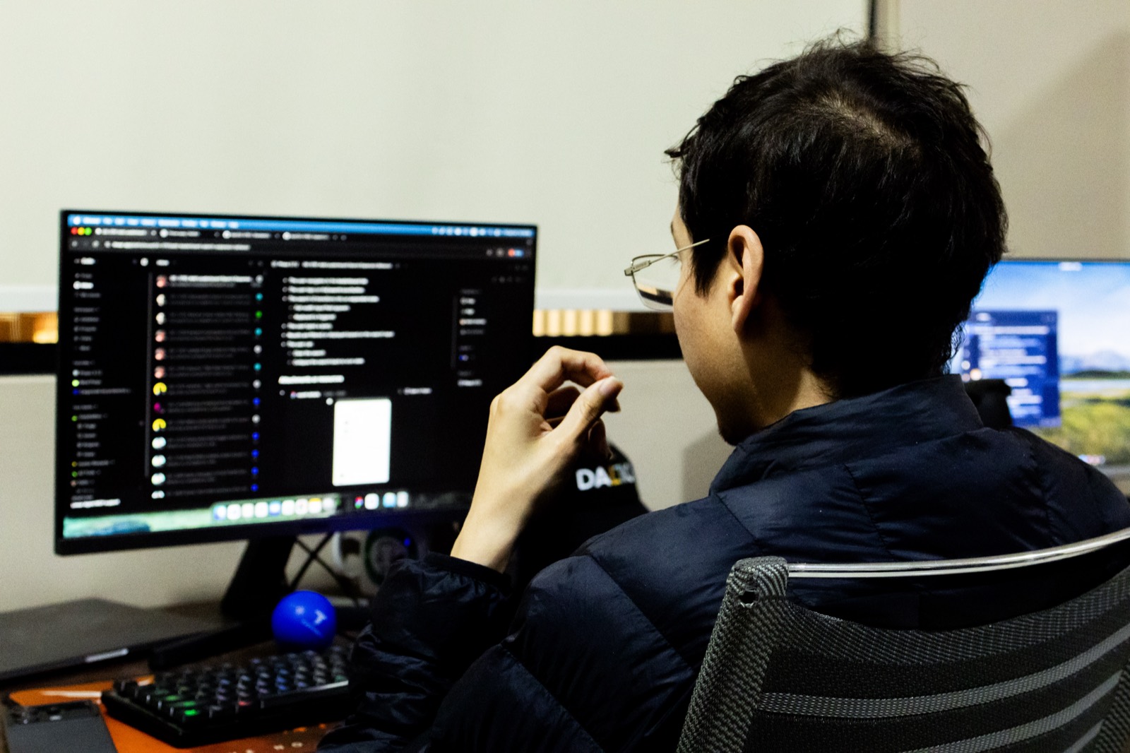 A Dallio engineer following the team's chat channels on a monitor at the nearshore studio in Ensenada, México