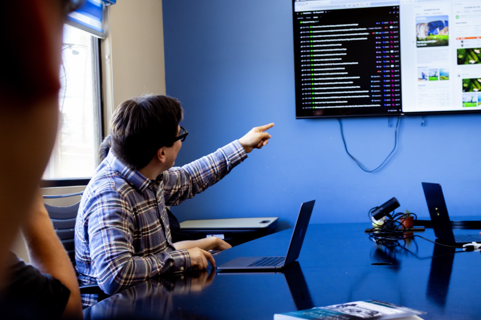 A Dallio engineer pointing at a project board on a wall display during a planning session in Baja California